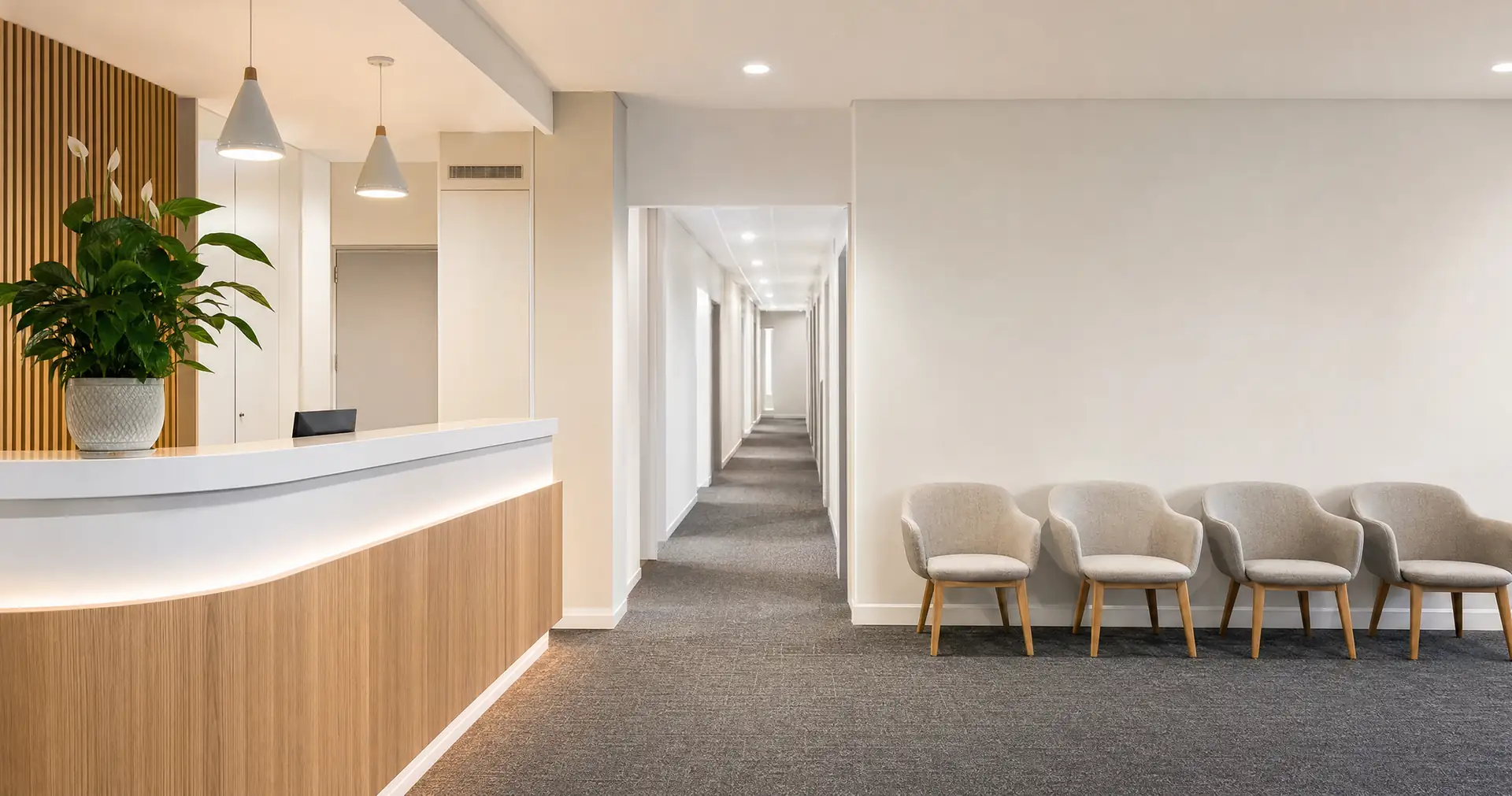 A reception desk and small waiting area in a clean modern medical practice